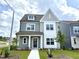 Charming two-story home with Hardie board siding and a well-manicured lawn on a sunny day at 2880 Quarry Rd # 163, Rolesville, NC 27571