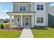 Welcoming front porch with classic columns and manicured landscaping leading to a modern, stylish home at 2880 Quarry Rd # 163, Rolesville, NC 27571