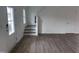 Hallway with stairway, entry door, and hardwood floors leading to other parts of the home at 2880 Quarry Rd # 163, Rolesville, NC 27571