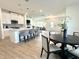 Bright, open-concept kitchen with white cabinets, island with bar seating, and stainless steel appliances at 2880 Quarry Rd # 163, Rolesville, NC 27571