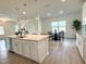 Modern kitchen featuring an island with a sink, stainless steel dishwasher, and adjacent dining area at 2880 Quarry Rd # 163, Rolesville, NC 27571