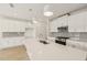 Modern kitchen with white cabinets, sleek countertops, and stainless steel appliances, offering a stylish cooking space at 2880 Quarry Rd # 163, Rolesville, NC 27571