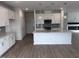 Bright kitchen featuring white cabinets, gray backsplash, stainless appliances and center island with sink at 2880 Quarry Rd # 163, Rolesville, NC 27571
