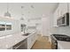 Bright kitchen features an island with stainless steel sink and all-white cabinetry, and stainless steel appliances at 2880 Quarry Rd # 163, Rolesville, NC 27571
