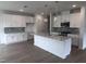 Bright kitchen with white cabinets, gray subway tile backsplash, stainless appliances and large island at 2880 Quarry Rd # 163, Rolesville, NC 27571
