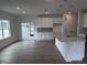 Spacious kitchen featuring white cabinets, gray backsplash, large island, and stainless steel appliances at 2880 Quarry Rd # 163, Rolesville, NC 27571