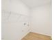 Empty laundry room with wood floors and a white wire shelf at 2880 Quarry Rd # 163, Rolesville, NC 27571