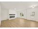 Spacious living room with wood floors, a modern fireplace, and ample natural light, creating a cozy atmosphere at 2880 Quarry Rd # 163, Rolesville, NC 27571
