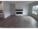 Spacious living room with modern fireplace and large window, featuring hardwood floors and white walls at 2880 Quarry Rd # 163, Rolesville, NC 27571