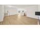 Open-concept living room with wood floors flowing into a modern kitchen, ideal for entertaining and Gathering living at 2880 Quarry Rd # 163, Rolesville, NC 27571
