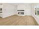 Bright living room with wood floors, modern fireplace, and large window offering a view of the neighborhood at 2880 Quarry Rd # 163, Rolesville, NC 27571