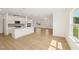Open-concept space with light wood-look floors, white walls, and modern fireplace at 2880 Quarry Rd # 163, Rolesville, NC 27571