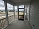 View from screened porch with white railings, showcasing the surrounding neighborhood and blue skies at 2880 Quarry Rd # 163, Rolesville, NC 27571