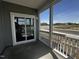 Screened-in porch features white railings and offers a glimpse of the outdoors and beautiful blue sky at 2880 Quarry Rd # 163, Rolesville, NC 27571