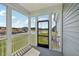 View from the screened porch with white railings overlooking a green lawn and construction area in the distance at 2880 Quarry Rd # 163, Rolesville, NC 27571