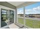 Spacious screened porch with white railings and a view of the street and blue sky with clouds at 2880 Quarry Rd # 163, Rolesville, NC 27571