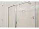 Modern glass-enclosed shower with white tile and built-in niche at 2880 Quarry Rd # 163, Rolesville, NC 27571