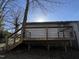 Back deck with wooden stairs, rail, and trees in the background at 292 Cedar Lake Rd # A, Chapel Hill, NC 27516