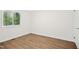 Bedroom featuring wood-look flooring, a window, and white walls at 292 Cedar Lake Rd # A, Chapel Hill, NC 27516