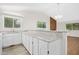 Open kitchen featuring white cabinetry, granite countertops, and an eat-in bar area at 292 Cedar Lake Rd # A, Chapel Hill, NC 27516