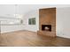 Bright living room featuring a brick fireplace, vaulted ceilings, and an adjacent kitchen area at 292 Cedar Lake Rd # A, Chapel Hill, NC 27516