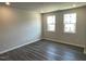 Bright bedroom with hardwood floors, recessed lighting, and large windows that provide natural light at 3009 Honeymyrtle Ln, Durham, NC 27703