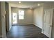 Bright living room featuring hardwood floors, neutral paint and a door to a rear porch at 3009 Honeymyrtle Ln, Durham, NC 27703
