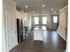 Bright kitchen featuring white cabinets, stainless steel appliances, and a central island with a sink at 3011 Honeymyrtle Ln, Durham, NC 27703