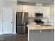 Well-lit kitchen featuring stainless steel appliances, subway tile backsplash, and quartz countertops at 3011 Honeymyrtle Ln, Durham, NC 27703