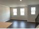 This home has a large open living room with tons of natural light and hardwood floors at 3011 Honeymyrtle Ln, Durham, NC 27703