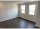 Bright living room with hardwood floors and large windows at 3011 Honeymyrtle Ln, Durham, NC 27703