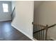 Staircase leading to second floor with hardwood steps and black iron railing at 3011 Honeymyrtle Ln, Durham, NC 27703