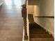 View down staircase featuring dark wood steps with white risers and banister leading to hardwood floors at 3011 Honeymyrtle Ln, Durham, NC 27703