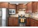 Kitchen with stainless steel appliances, granite countertops, and dark wood cabinets at 306 Currituck Ln, Durham, NC 27703