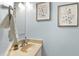 Powder room features vanity, mirror, and two framed art pieces at 308 Summerfield Crossing Road, Chapel Hill, NC 27514