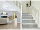 Open living space featuring a staircase, fireplace, and access to outdoor area at 308 Summerfield Crossing Road, Chapel Hill, NC 27514