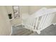 Carpeted stairway featuring painted white wood railing, offering a view from above at 308 Summerfield Crossing Road, Chapel Hill, NC 27514