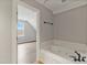 Bathroom featuring a large soaking tub next to an open doorway to another room at 309 Neuse Ridge Dr, Clayton, NC 27527