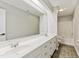 Neutral bathroom featuring a double sink vanity with a large mirror and a tub with shower at 309 Neuse Ridge Dr, Clayton, NC 27527