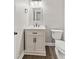 Updated half bathroom with custom vanity, modern fixtures, and dark wood floors at 309 Neuse Ridge Dr, Clayton, NC 27527