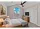 Lovely bedroom featuring a ceiling fan, large window, and light wooden decor at 309 Neuse Ridge Dr, Clayton, NC 27527