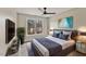 Comfortable bedroom features a ceiling fan, large window, and contemporary decor at 309 Neuse Ridge Dr, Clayton, NC 27527
