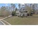 Two story home featuring a front porch, mature landscaping and a long driveway at 309 Neuse Ridge Dr, Clayton, NC 27527
