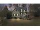 Charming two-story home with landscaped yard, inviting porch, and traditional architectural details, set amidst mature trees at 309 Neuse Ridge Dr, Clayton, NC 27527