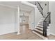 Spacious foyer features hardwood floors, staircase with decorative railing and an open floorplan at 309 Neuse Ridge Dr, Clayton, NC 27527