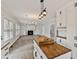 Open concept living room with fireplace and built-in shelving seen from the kitchen with wood countertops at 309 Neuse Ridge Dr, Clayton, NC 27527
