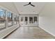 Bright sunroom with multiple windows and glass doors leading to an outdoor space at 309 Neuse Ridge Dr, Clayton, NC 27527