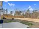 Large backyard with a wood fence, concrete patio and fire pit at 3413 Dragonfly River Ct, Raleigh, NC 27604