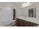 Bathroom featuring a dark vanity, framed mirror, toilet, and a bathtub with a shower at 3413 Dragonfly River Ct, Raleigh, NC 27604