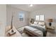 Well appointed bedroom features a bed with decorative pillows, side tables, and natural light at 3413 Dragonfly River Ct, Raleigh, NC 27604